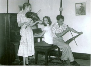 My roots: My great grandmother, Theodosia Wagnon Iles with her son, Lloyd Iles and my Aunt Margie on the piano. Circa 1950.