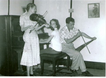 At the Old House: My great grandmother, Theodosia Wagnon Iles with her son, my PaPa Lloyd Iles and my Aunt Margie on the piano. Circa 1950.