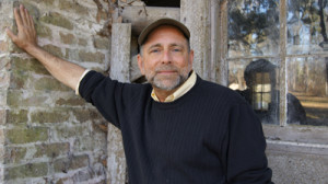 Curt Leaning Against Fireplace at Old House