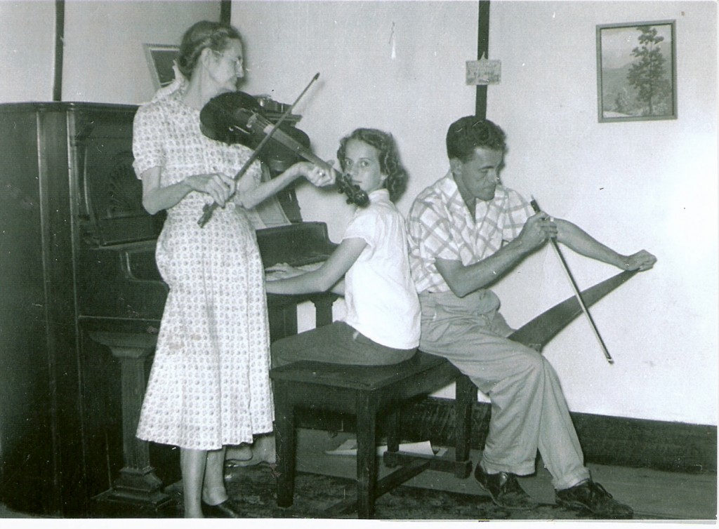 Doten, playing fiddle, with her son Lloyd Iles on "handsaw" and grandaughter Margie Nell on the piano. Dry Creek Old House circa 1950