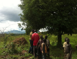 Hydrologist Silva and Pastor Paul siting drilling site. Notice adjacent tree and large termite hill.  Both are good indicators of good water underneath. 