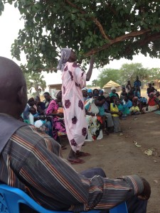 South Sudanese woman sharing at refugee camp.