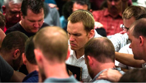 A group of leaders praying with David Platt in Thailand. Our colleague Jay Taliaferro is to Platt's right.