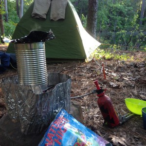 Campsite: tent in background, cooking stove in front.